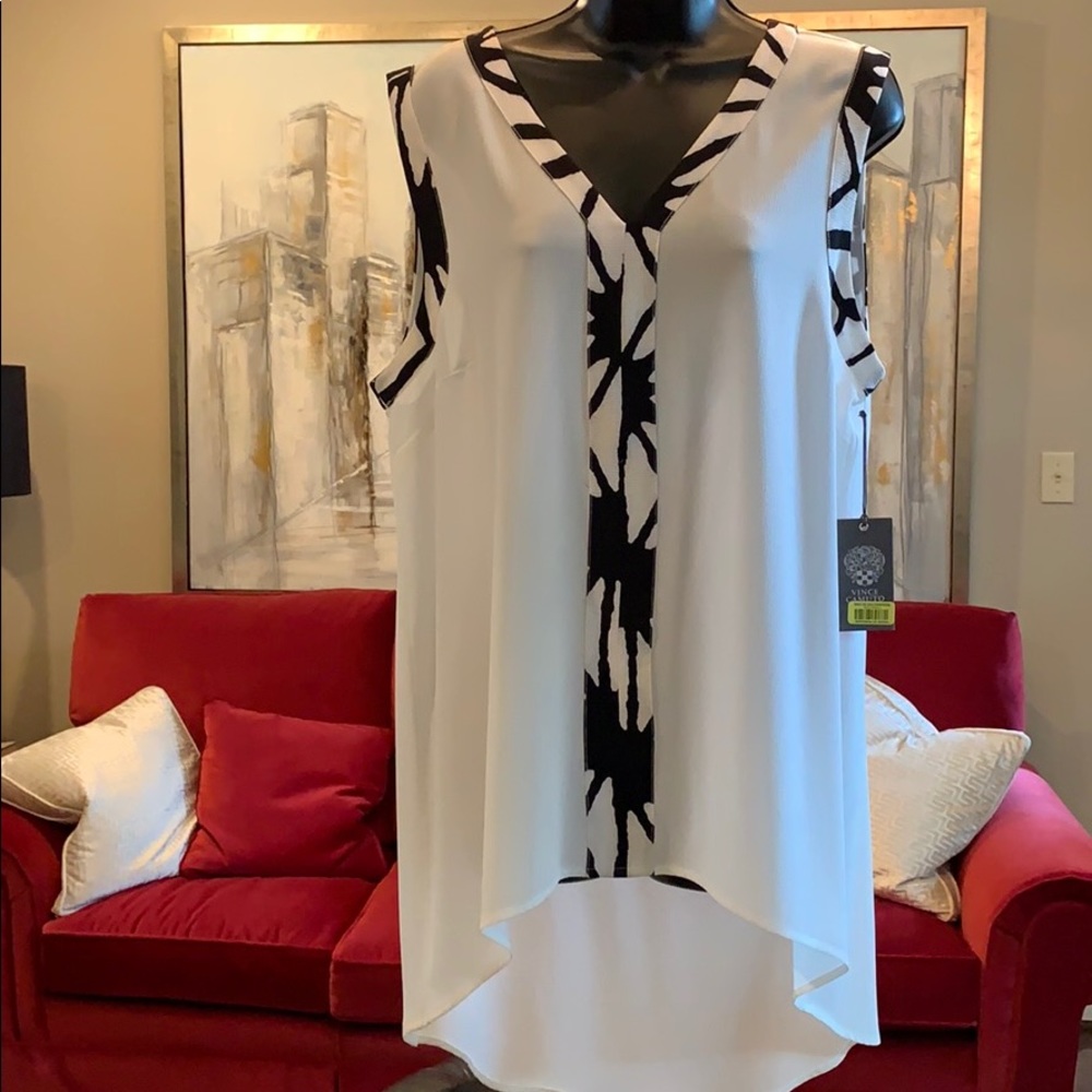 High low shell  accented at sleeve and neckline.